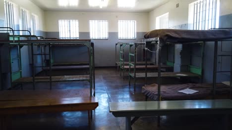 a follow shot exploring a group cell at robben island prison in cape town, south africa