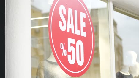 sale 50% off sign in shop window