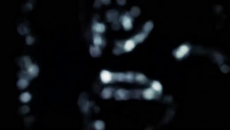 a close-up view reveals a cryptic symbol against a dark background. the complex patterns and shadows create an enigmatic atmosphere, inviting viewers to ponder its meaning.