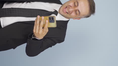 Vertical-video-of-Businessman-dancing-with-phone-in-hand.