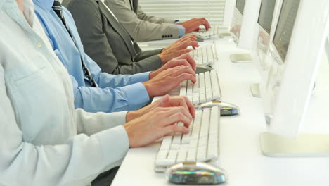 close up view of hands of businessman typing on keyboard