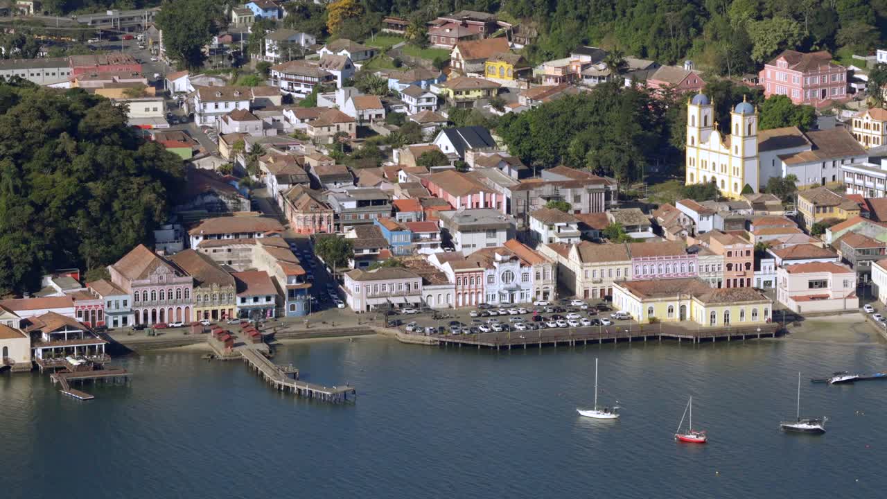 Low-angle drone glide near historic district, with a cathedral visible nearby, capturing the charm of the old city. Clear afternoon
