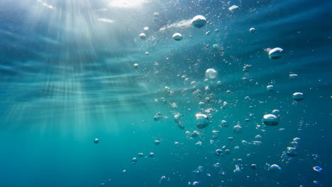 sunlight and bubbles under the ocean surface