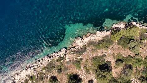 overhead shot of inviting turquoise mediterranean waters and rocky shoreline