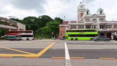 buses and cars crossing an urban intersection.