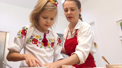 mother and daughter baking cupcakes