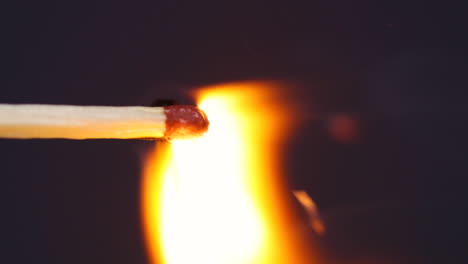 ignition matches close up macro shot from side view captured in front of black background in slow motion at 60 fps