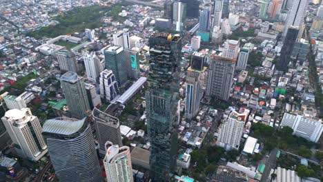 Drone-Shot-of-Mahanakhon-Tower-skywalk,-rooftop,-in-Bangkok,-Silom-area,-business-district,-downtown