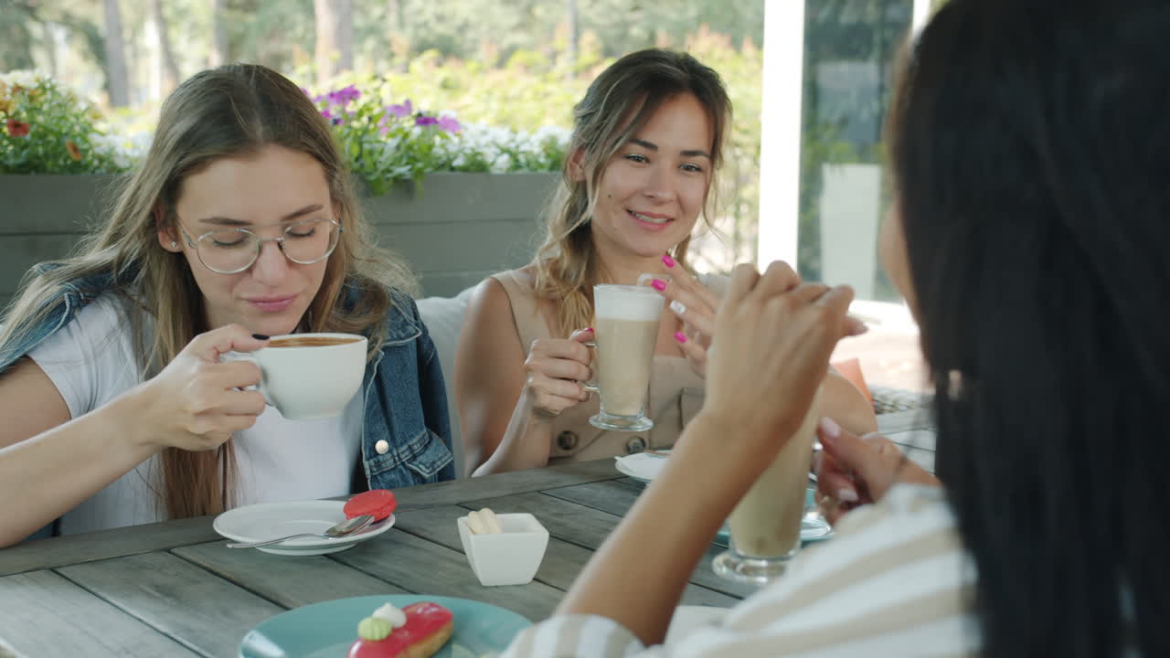 Friends enjoying coffee and pastries outdoors