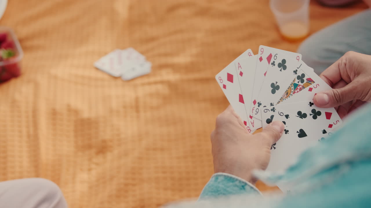 Friends Playing Cards at a Summer Picnic