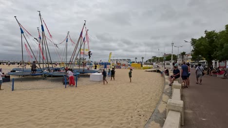 people enjoying trampoline on a sandy beach