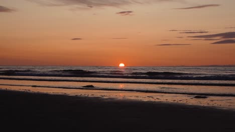 man running with guitar in back sand beach at sunset-21