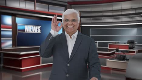 happy indian senior journalist showing okay sign