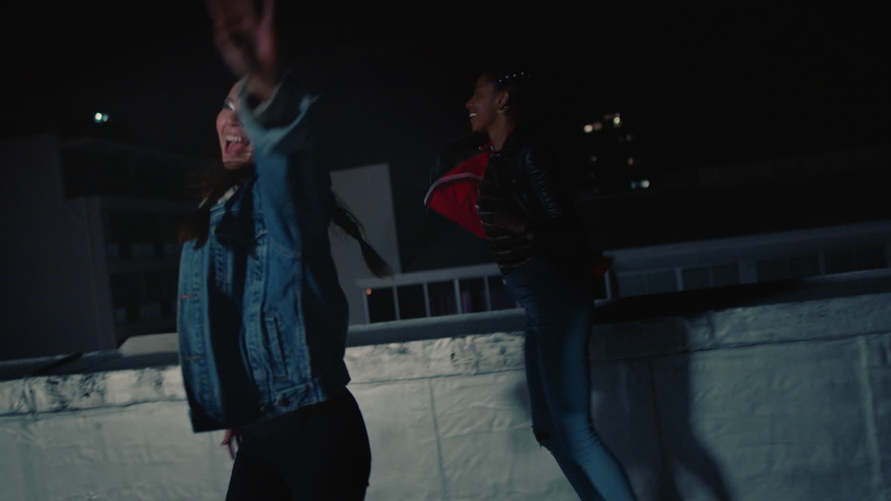 happy group of friends dancing to lively rooftop party music enjoying weekend celebration in urban city at night