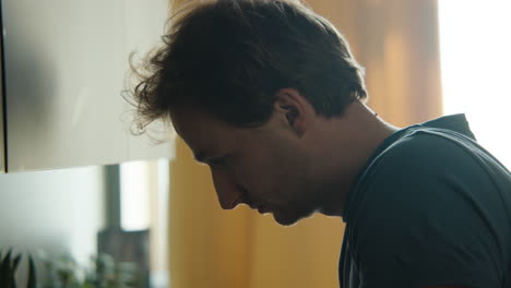 man looking sad in kitchen