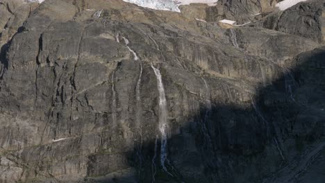 Waterfall-Cascading-On-Massive-Cliff-Boulder-At-Joffre-Lakes-Provincial-Park-In-British-Columbia,-Canada