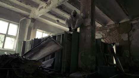 worker in protective suit jumping from the destroyed locker to the camera