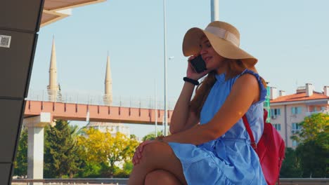 Caucasian-white-woman-sits-on-a-train-station-and-patiently-waits-for-the-next-train