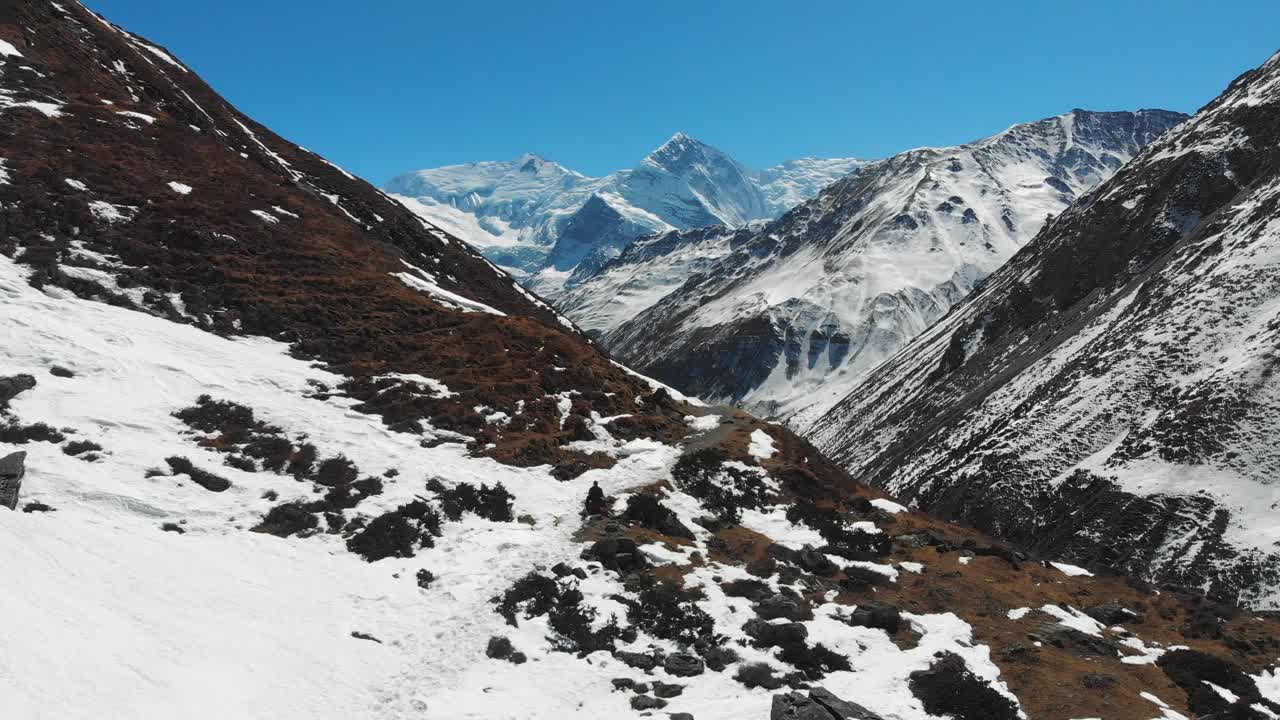 Aerial zoom out shot of Mount Annapurna three and Ganapurna Himalayas Mountain from Manang Valley, Nepal.