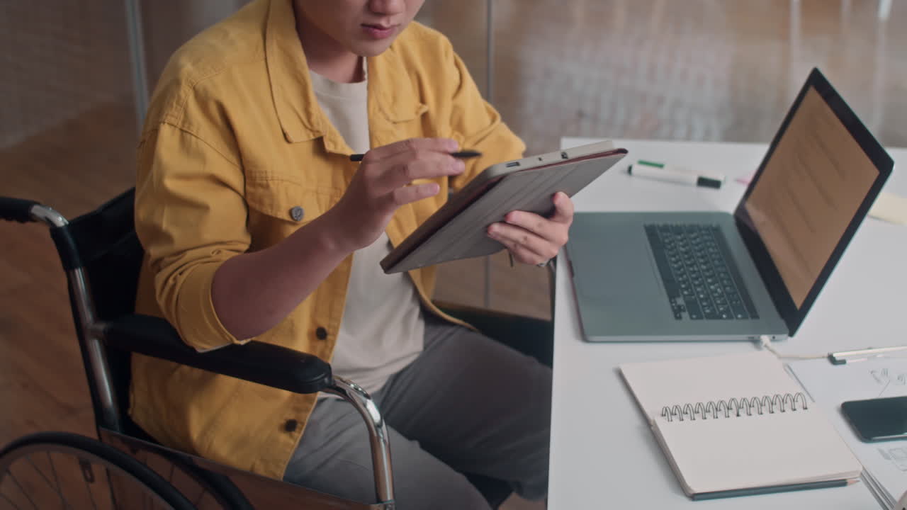 Coder with Disability Testing Software App on Digital Tablet at Office Desk