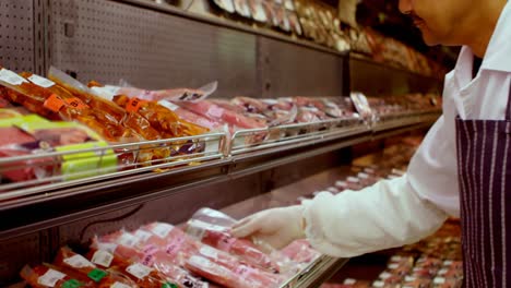 Butcher-arranging-wrapped-meat-in-rack-4k