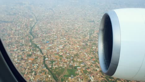 close up of airplane engine from window, during landing over city