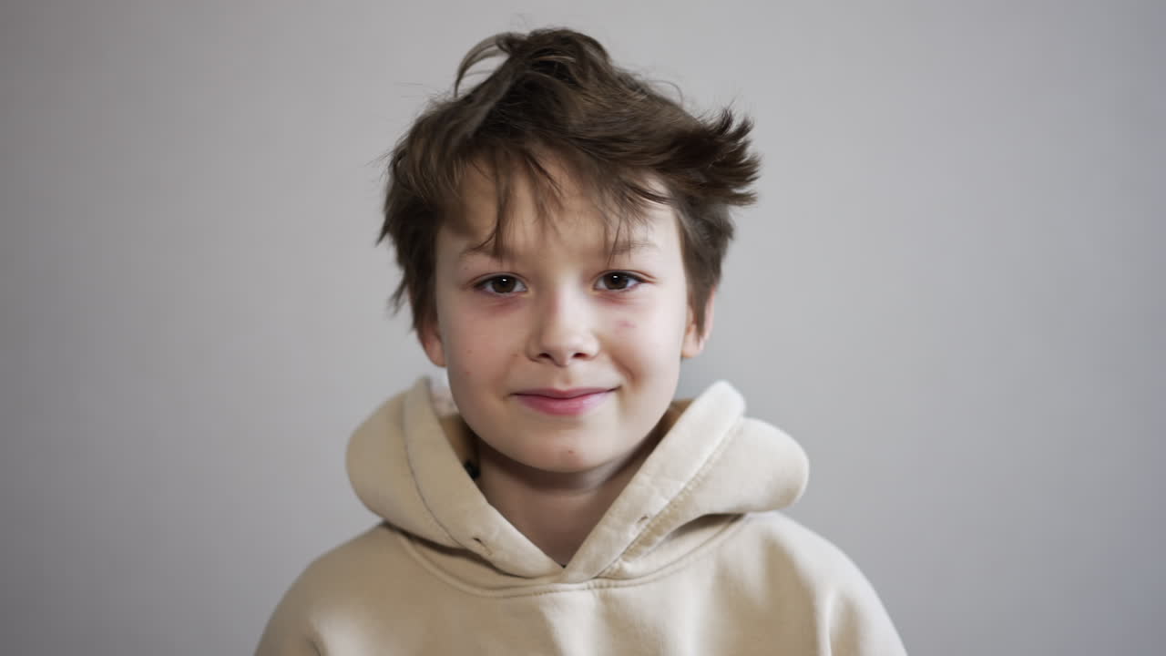 Boy with hand on head