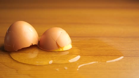 a cracked egg on a wooden table