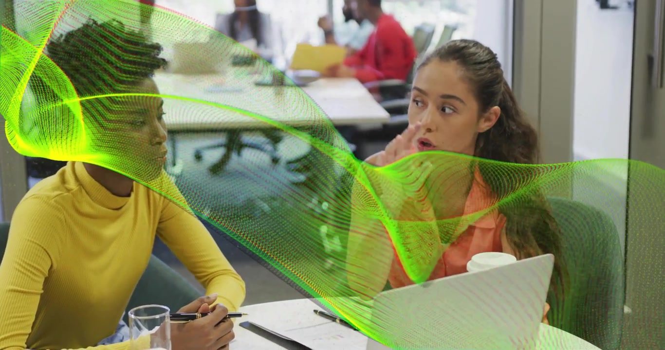 Positioning laptop and notebook, coworker animating highlights in office as colleague taking notes