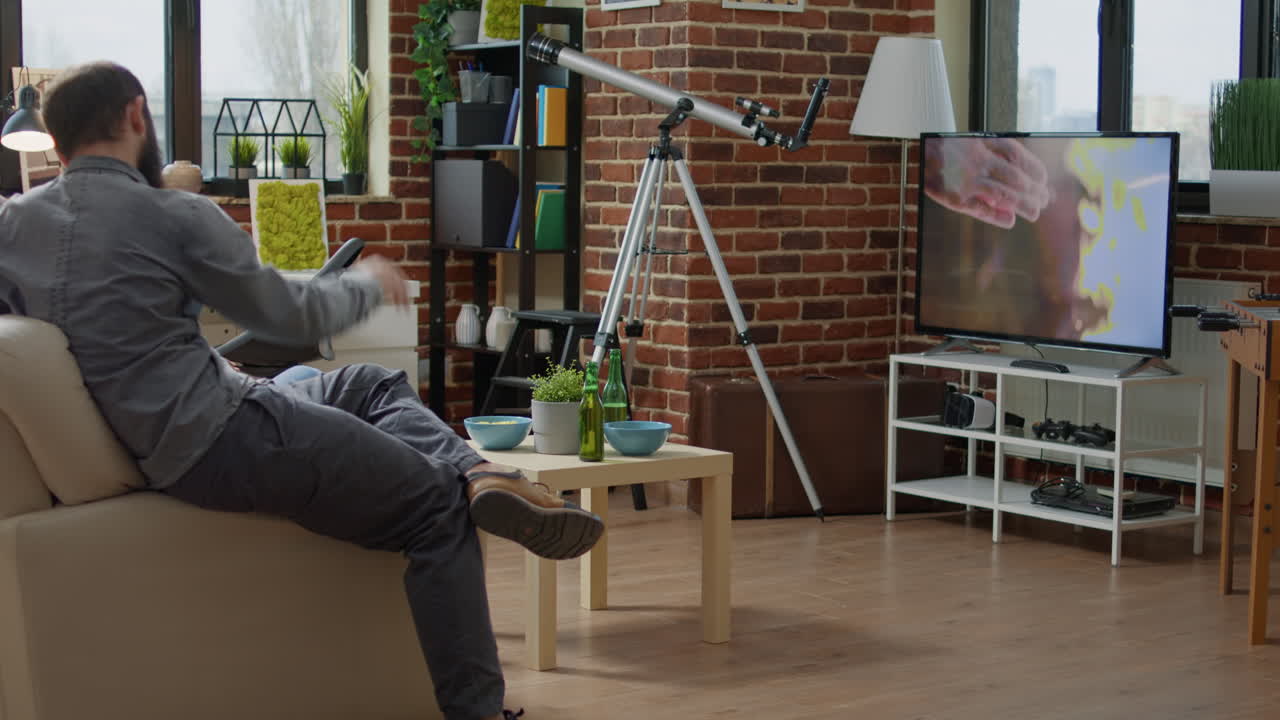 Diverse group of people sitting together and watching film on TV