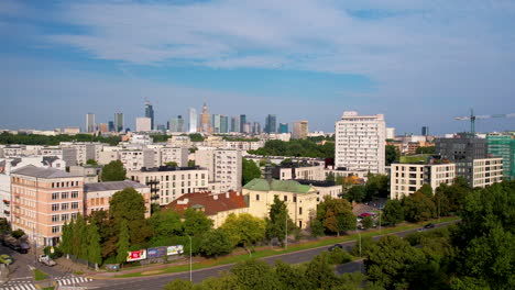 Aerial-view-of-Warsaw-skyline-from-over-park-in-daytime,-Poland