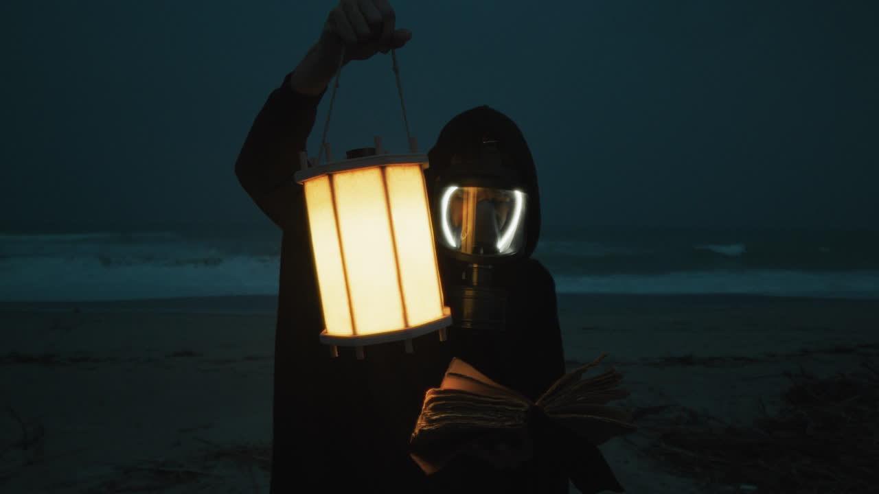 Man With Gas Mask Reads Mysterious Book Near Stormy Ocean At Night