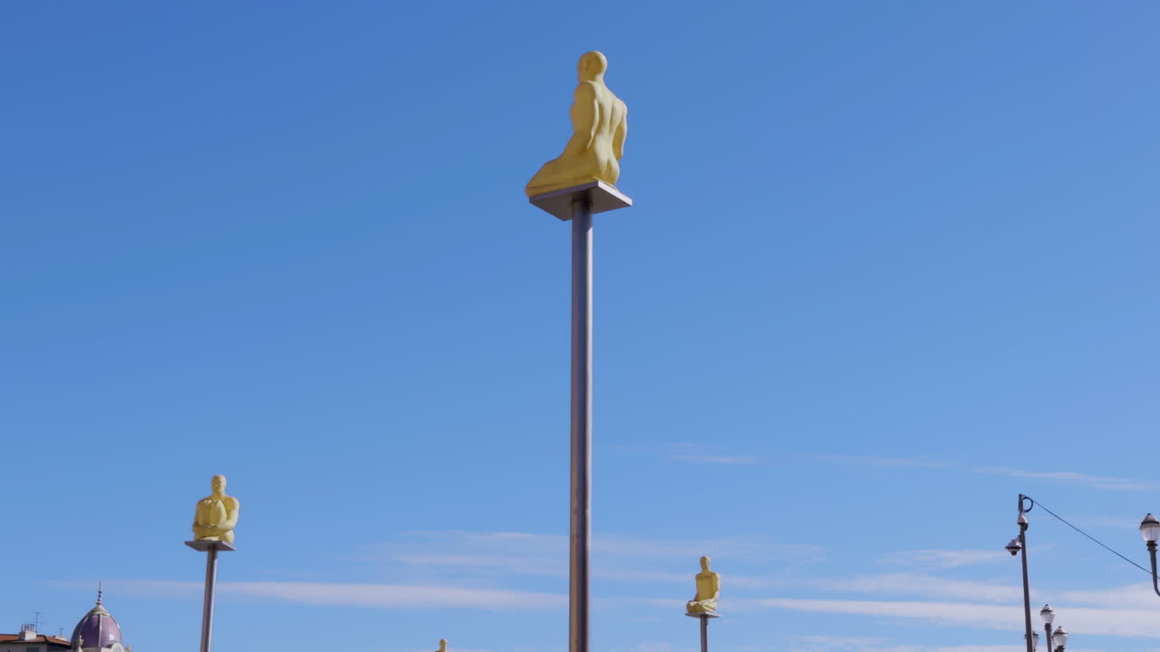 Yellow Figures on Metal Poles