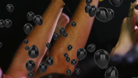 floating black bubbles over face and arms in dim lighting, creating animation