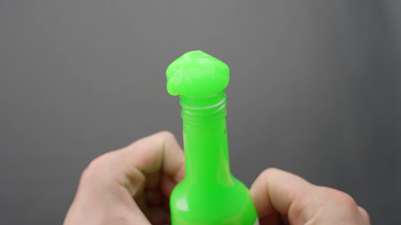 Neon green slime squeezed out of bottle ASMR by hands in pov