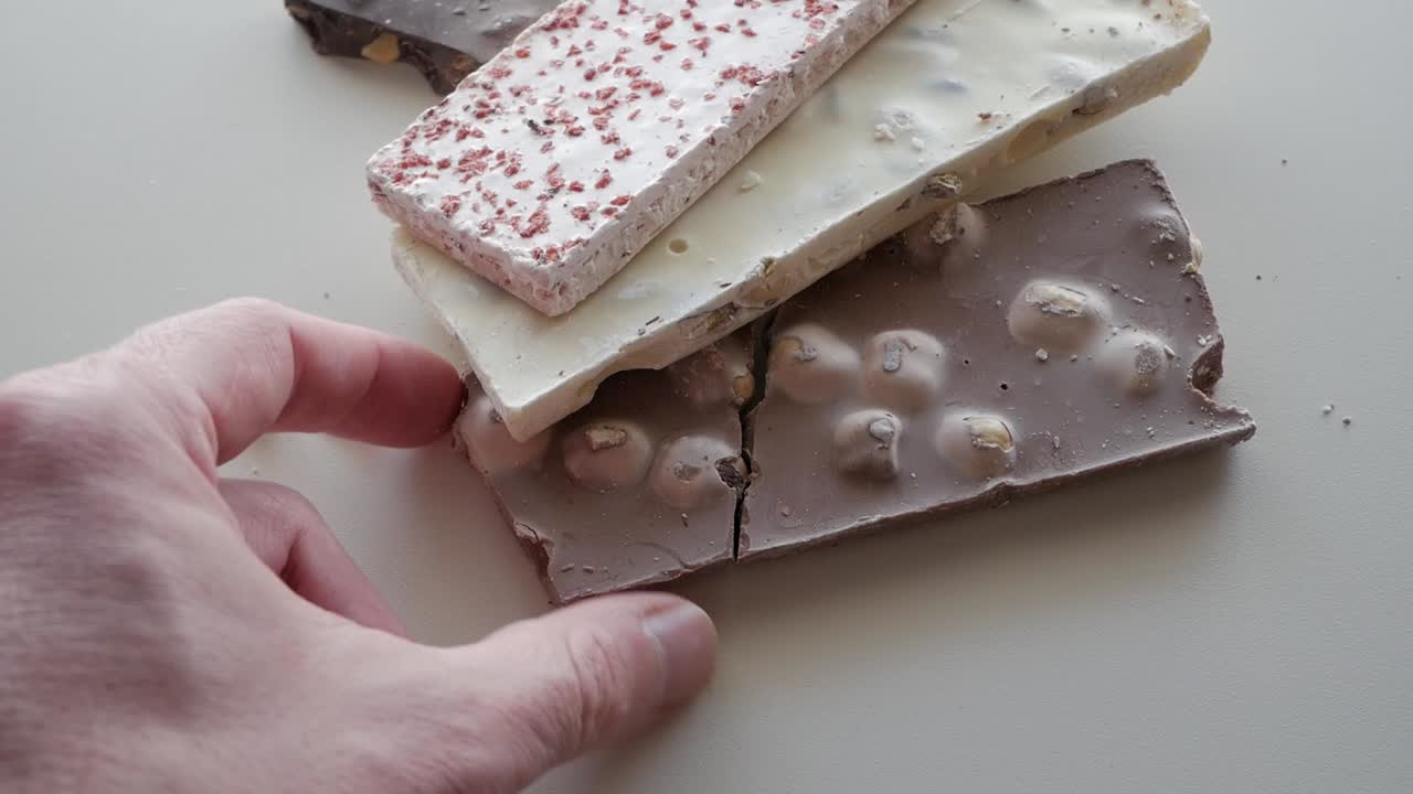 Assorted chocolate bars, white background, calm food setting, delicious