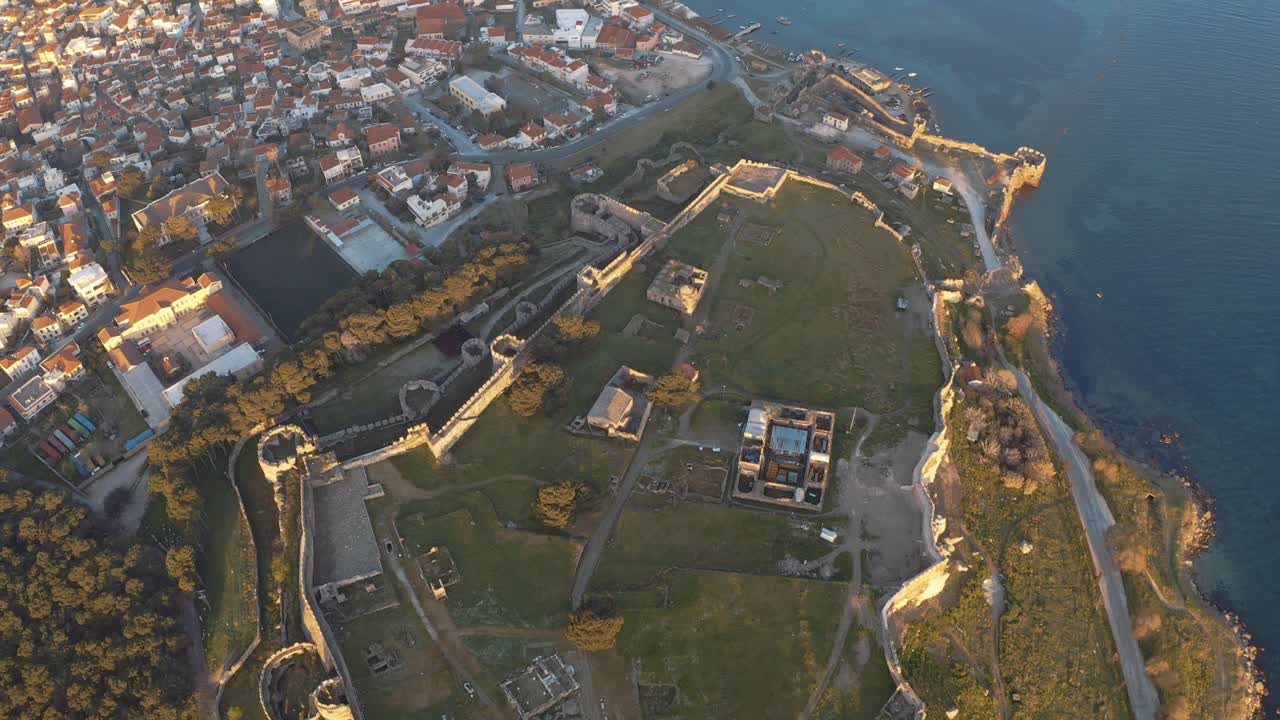Top down Drone Flight over mitilini castle, lesvos, air view revealing sunrise at sea, lesbos, greece