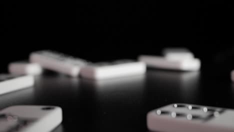 white domino dice fall on a black background