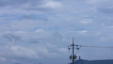 telephone pole of timelapse moving clouds