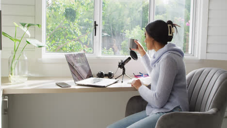 video of biracial woman taking part in online interview on laptop at home