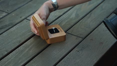 isolation shot of a engagement ring box as a photographer handles it