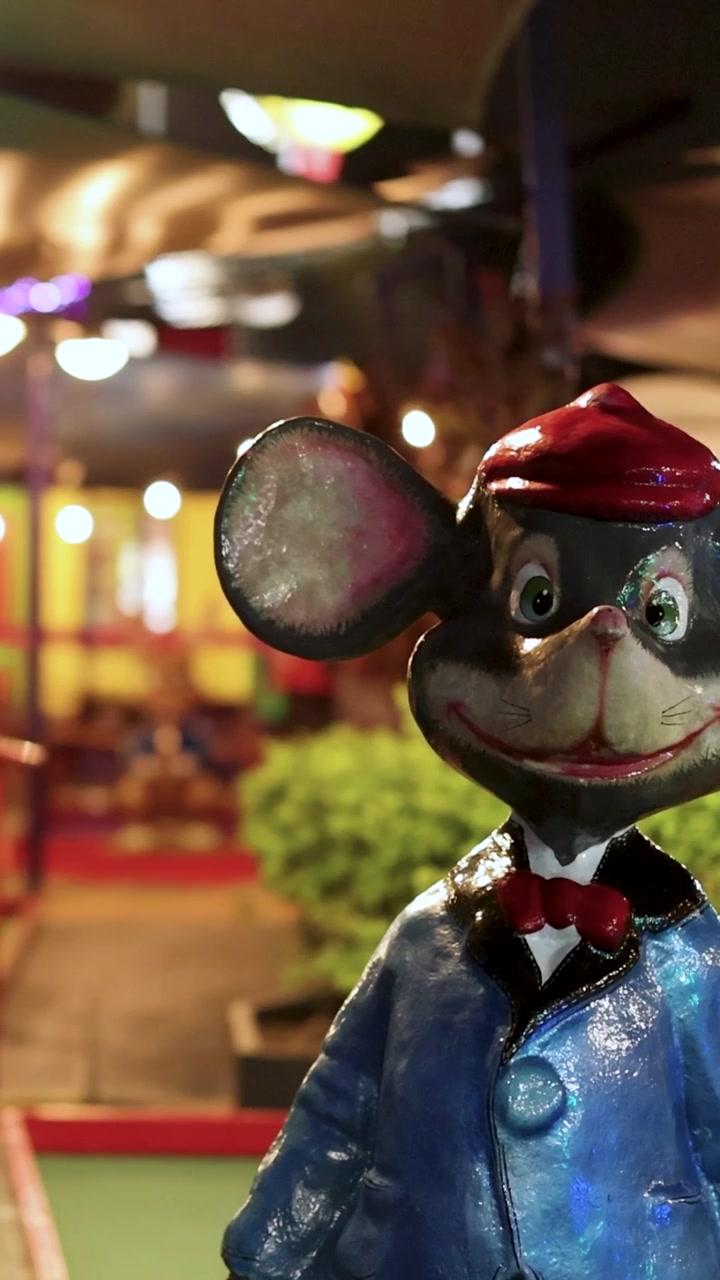 Animated mouse explores a vibrant mini-golf course
