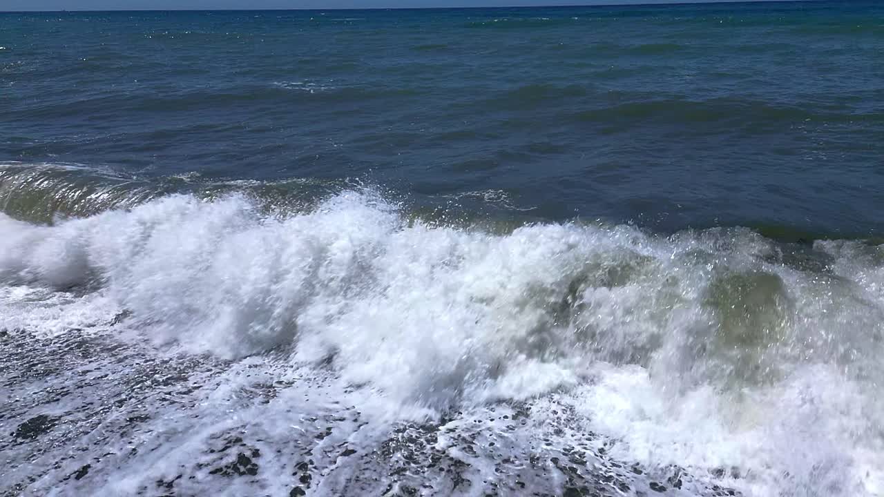 Crashing waves on the beach. Slow motion. Aerial view. Wave foam. Coastline. Andalusia. Spain.
