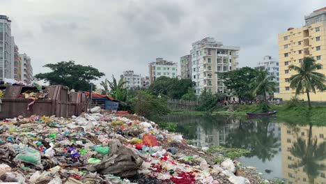 plastic pollution contaminate river water in dhaka bangladesh, tilt down, day