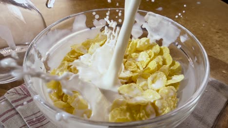 Crispy-yellow-corn-flakes-into-the-bowl-for-the-morning-a-delicious-Breakfast-with-milk.-Slow-motion-with-rotation-tracking-shot.