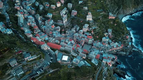 4k aerial view of the village of manarola, cinque terre in italy along the coast of the ligurian sea and view directly above the small community