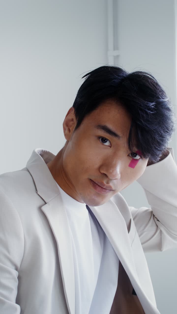 Stylish Man with Pink Tape on Eye