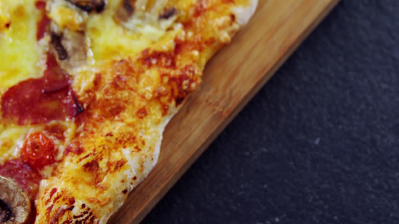 Baked pizza on wooden board