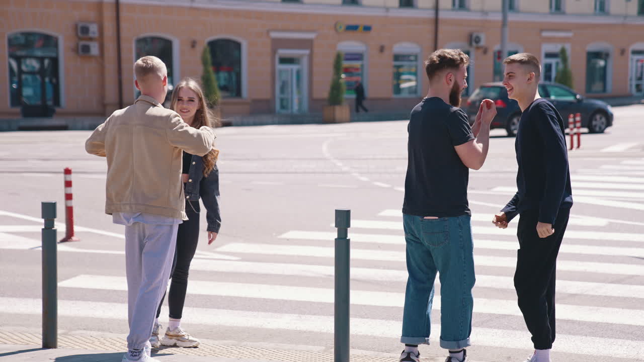 People cross the road. Young friends crossing street in city center