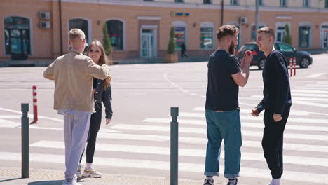 people cross the road. young friends crossing street in city center
